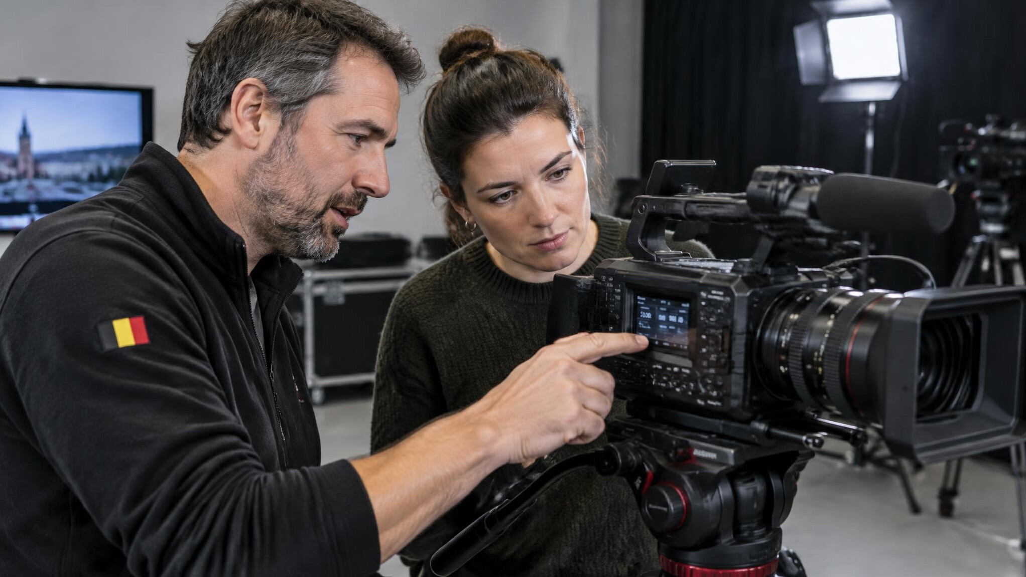 Trainer showing camera settings to a student